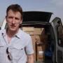 An undated photo showed Peter Kassig standing in front of a truck filled with supplies for Syrian refugees.